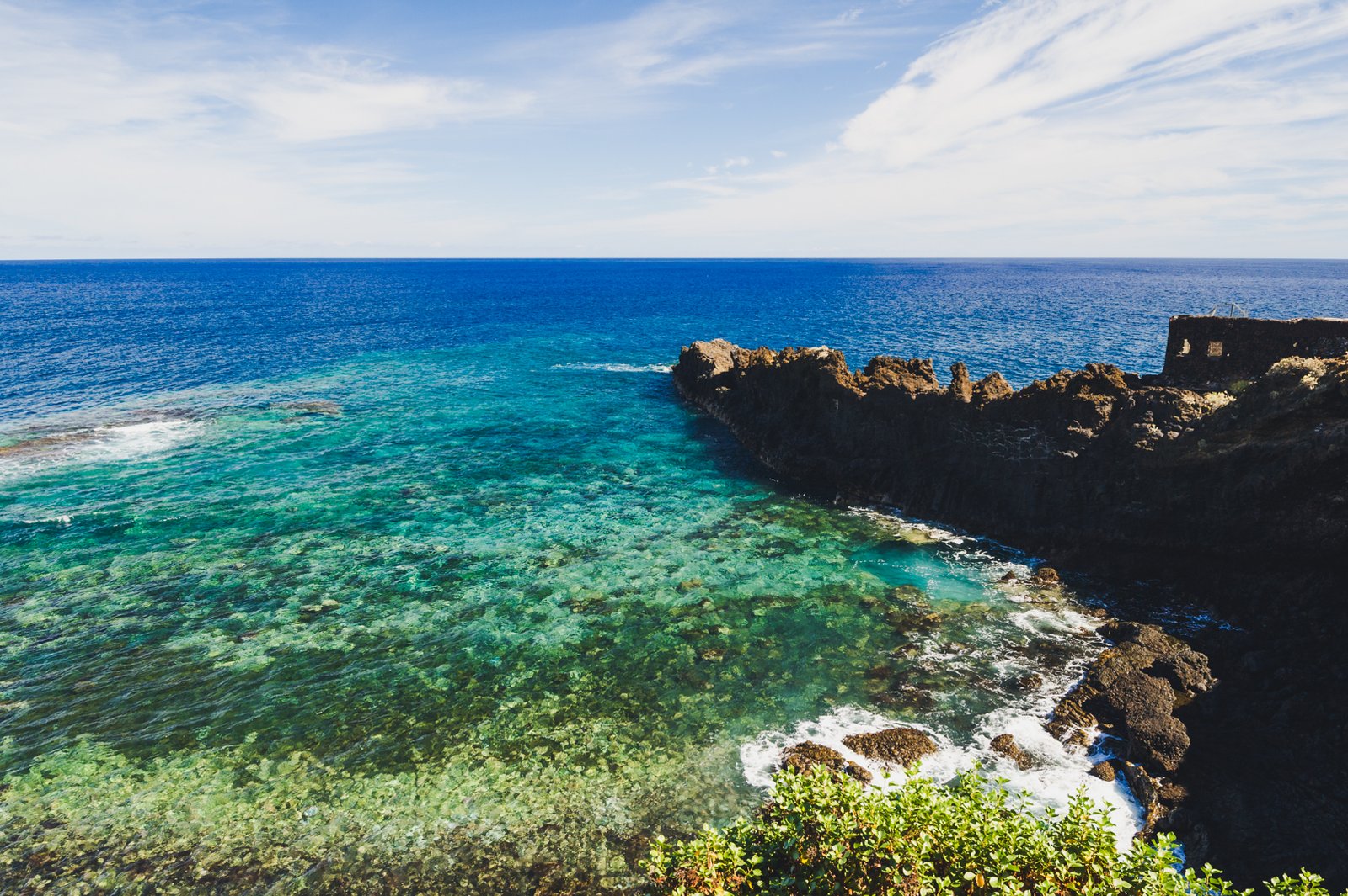 La Palma. El Charco Azul. Clear blue ocean and vegetation.